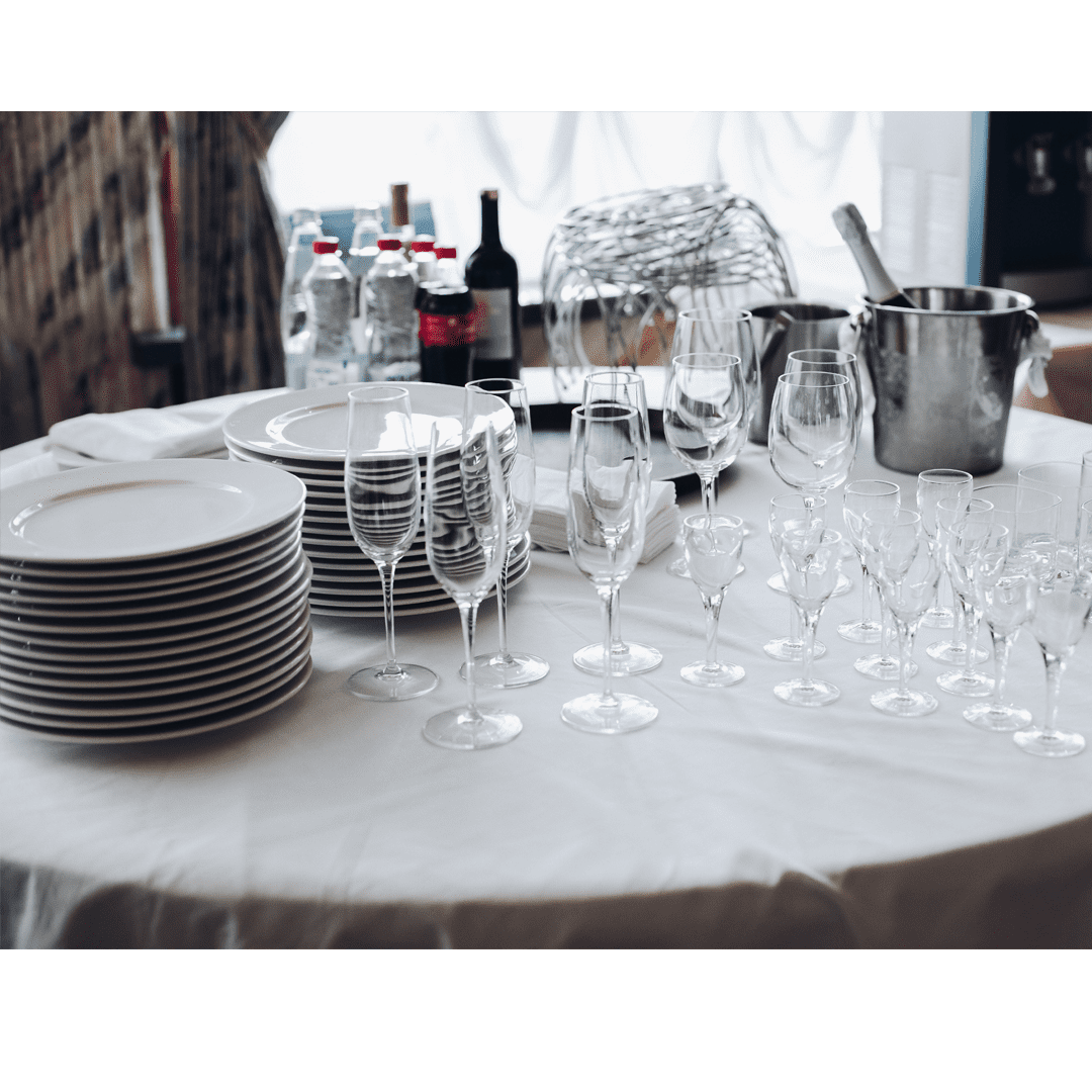 asortyment naczynia kuchenne biały widok na stół biały okrągły stół ze stosami białe talerze puste